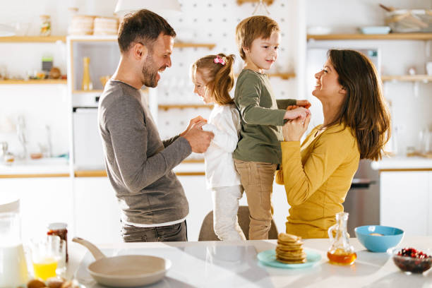 istock Happy parents having fun with their kids in dining room. 2176620016