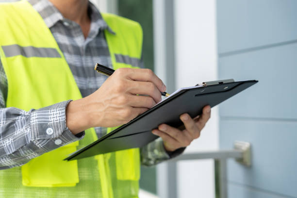 istock inspector or engineer is inspecting construction and quality assurance new house using a checklist. Engineers or architects or contactor work to build the house before handing it over to the homeowner 2176622800