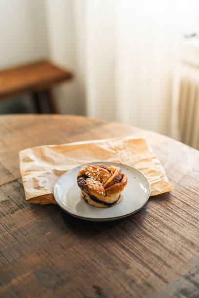 istock Freshly baked cinnamon bun on rustic wooden table 2176624100
