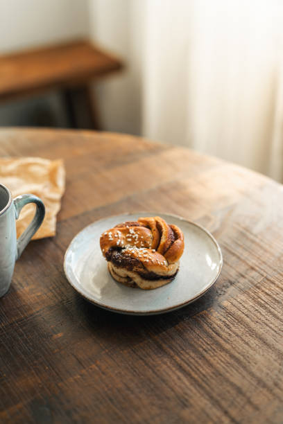istock Freshly baked cinnamon bun on rustic wooden table 2176624115