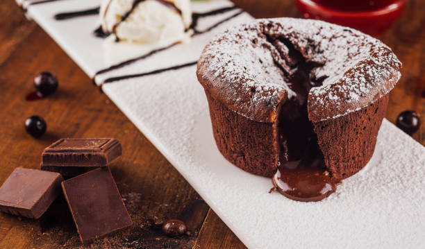 istock Delicious chocolate lava cake oozing on white plate with ice cream 2176626131