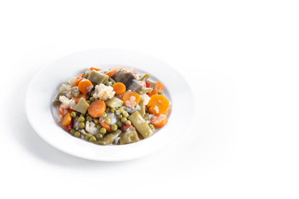 Frozen vegetable stew on a plate isolated on white background