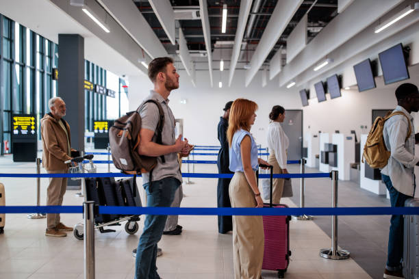 istock People waiting in a queue in an airport terminal 2176627058