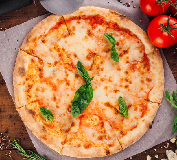 istock Delicious pizza margherita lying on wooden table 2176628248