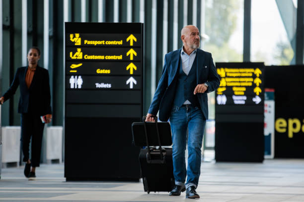 istock Senior man walking through an airport terminal 2176628468
