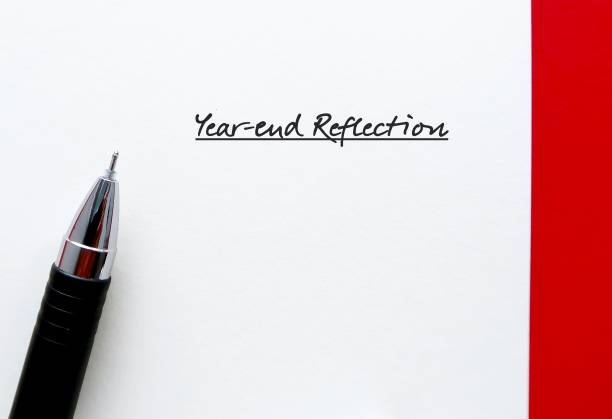 Note paper with handwritten text YEAR-END REFLECTION - best end-of-year rituals to reflect or review success, failures or and lessons learnt from past year and plan for the next coming year