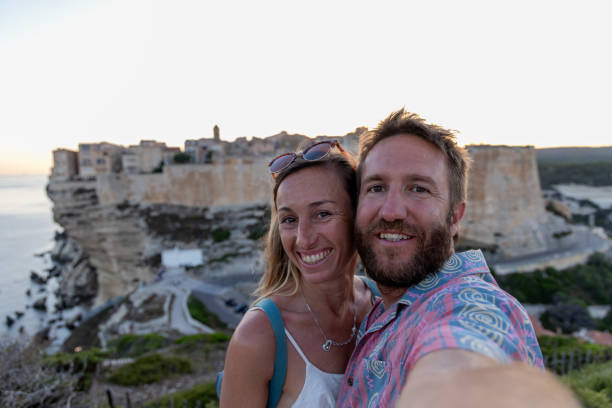 istock Happy Couple Taking a Selfie with Cliffside Town at Sunset 2176629245