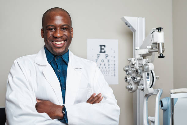 istock Confident Optometrist in White Coat Smiling in Modern Office with Eye Examination Equipment 2176629531
