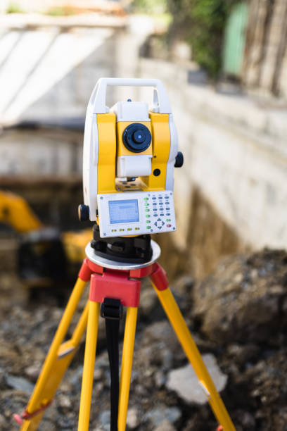istock A precision surveying instrument set up on a construction site with earthmoving equipment in the background during daylight hours 2176629649