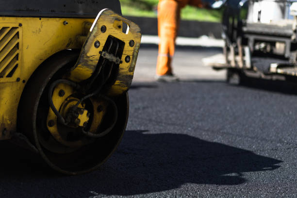 istock Workers use a roller to compact asphalt on a road construction site in the afternoon sunlight, showcasing construction efforts 2176629676