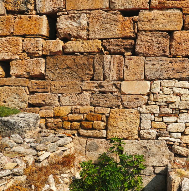 istock Sunlit Ancient Stone Wall Vertical Close-Up Shot 2176632300
