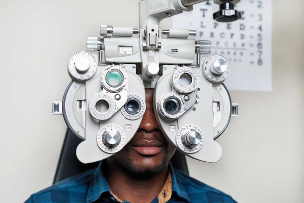 istock Optometrist Conducting Eye Exam with Modern Equipment at Optical Clinic 2176632425
