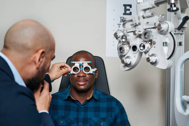 istock Optometrist Conducting Eye Examination on Client with Phoropter in Modern Office Setting 2176632746