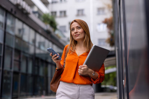 istock Professional woman checking her phone in an urban environment 2176633115