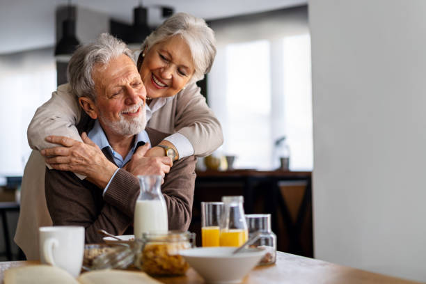istock Beautiful senior couple having fun, smiling together while enjoying breakfast together 2176633624