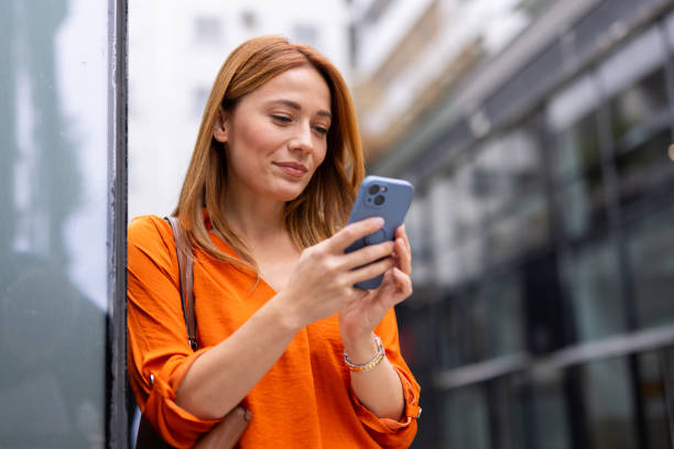 istock Businesswoman using her phone while navigating the city streets 2176634580