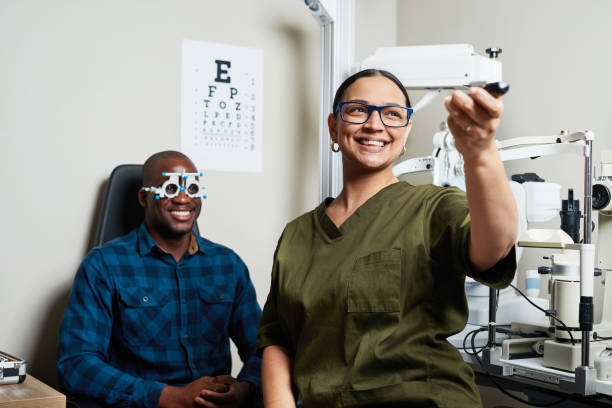 istock Optometrist Conducting Eye Exam with Patient Wearing Trial Frames in Modern Optometry Office 2176634963