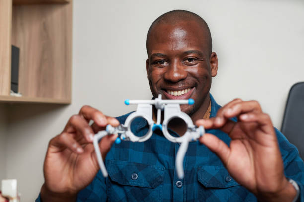 istock Smiling Optometrist Holds Eye Testing Equipment in Professional Office Setting 2176635579