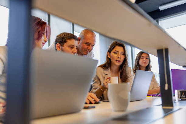 istock Multiracial Business Team Engaged in a Productive Staff Meeting. Diverse Group Planning Strategically, Brainstorming, Collaborating, and Working a Modern Office Setting 2176635607