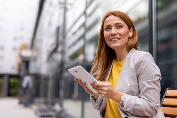 istock Businesswoman using a tablet in the city 2176637625