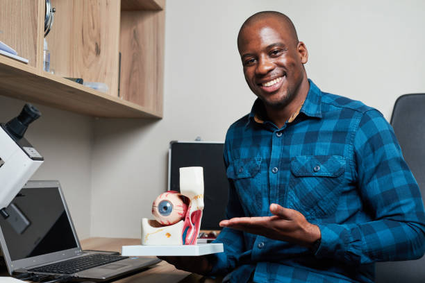 istock Confident Optometrist in Blue Plaid Shirt Holding Eye Model in Modern Office 2176638102