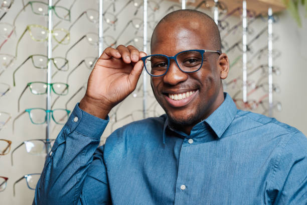 istock Smiling Optometrist Business Owner Adjusting Stylish Eyeglasses in Optical Store 2176639949