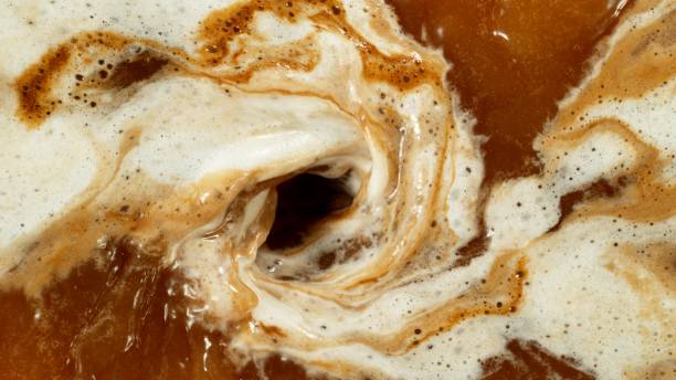 istock Macro Shot of Pouring Milk into Coffee 2176640909