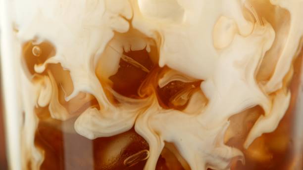 istock Macro Shot of Pouring Milk into Coffee 2176641070
