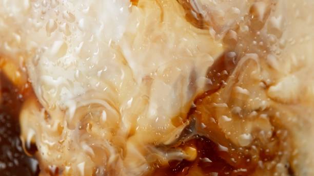 istock Macro Shot of Pouring Milk into Coffee 2176641084