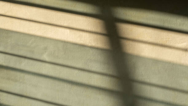 istock An abstract image of shadows cast by window curtains on a textured wall, creating a minimalist and serene composition with soft lighting and geometric patterns. 2176643649