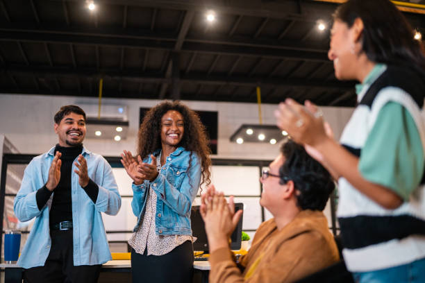 istock Young coworkers applauding during meeting at office 2176645748