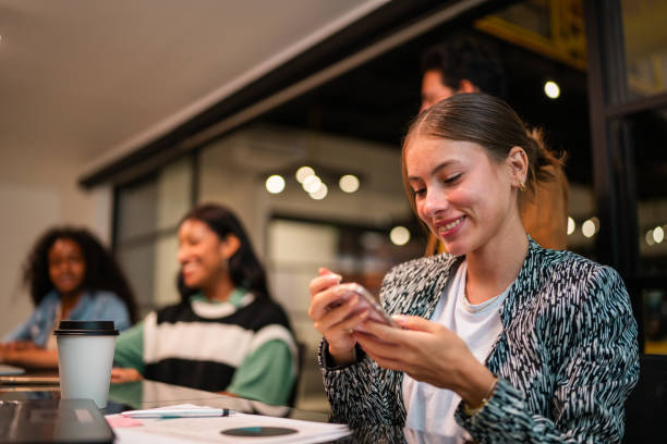 Young businesswoman working using mobile phone at office
