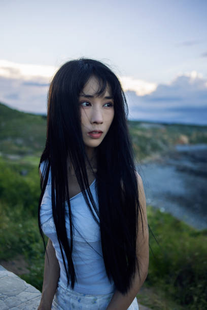 Asian beauties enjoying the sunset by the seaside