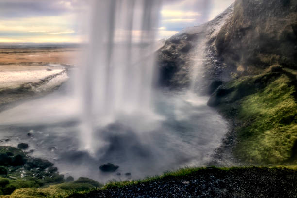 waterfall Seljalandsfoss as the sun sets on a summer evening in southern Iceland