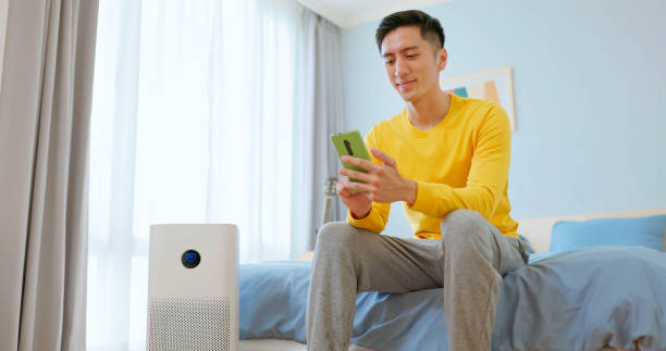 istock Asian male enjoy air purifier 2176652688