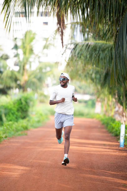 istock Male Runner Jogging on a Scenic Outdoor Trail 2176652776