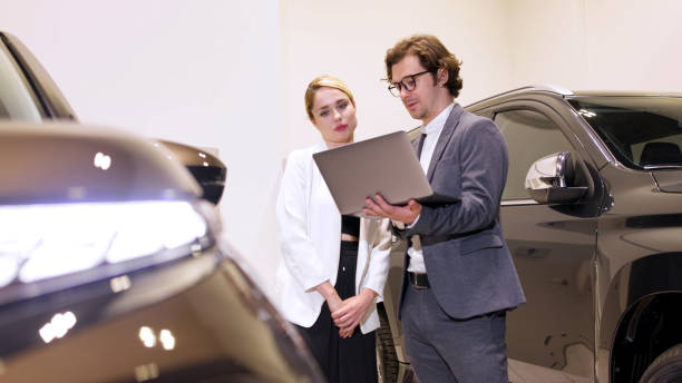istock Car salesman and female customer 2176655061