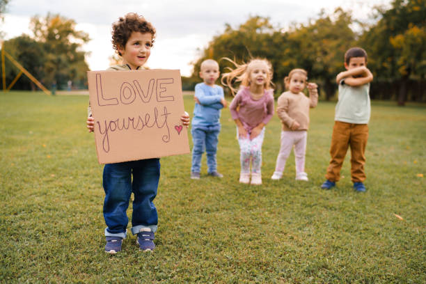 istock Boy holding sign Love yourself in nature 2176655805