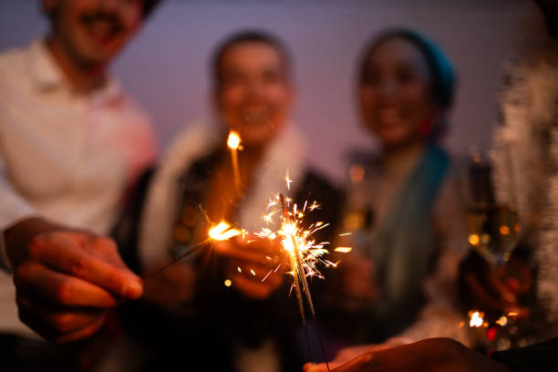 istock Joyful friends lighting sparklers and having fun at a celebration 2176658207