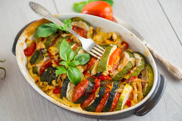 istock prepared baked zucchini and tomatoes in circles in a ceramic form, vegetable snack 2176658672