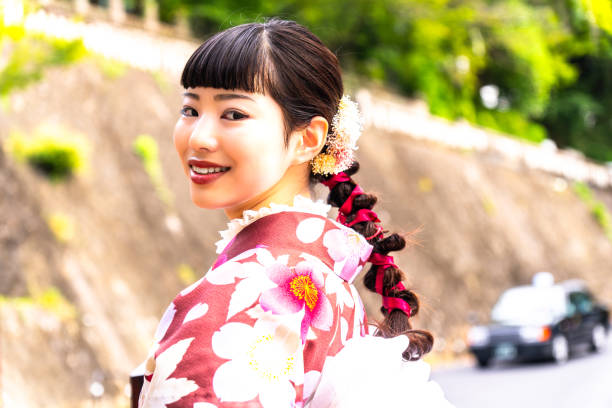 istock A woman in a kimono walking around town 2176660049