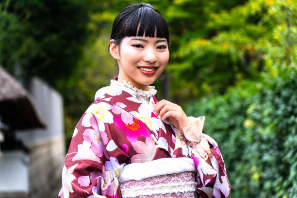 istock A woman in a kimono walking around town 2176660104
