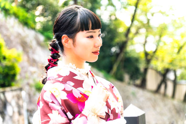 istock A woman in a kimono walking around town 2176660189