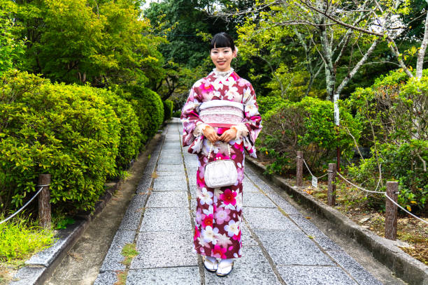 istock A woman in a kimono walking around town 2176660491