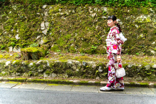 istock A woman in a kimono walking around town 2176660773