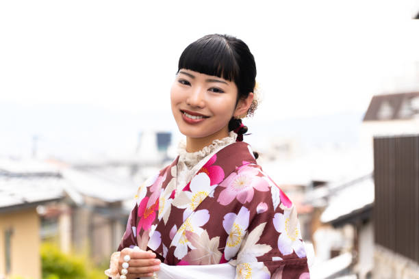 istock A woman in a kimono walking around town 2176660814