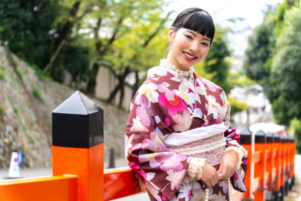 istock A woman in a kimono walking around town 2176661431