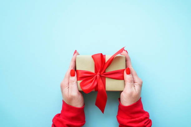 istock Boxing day. Woman giving christmas present. 2176661697