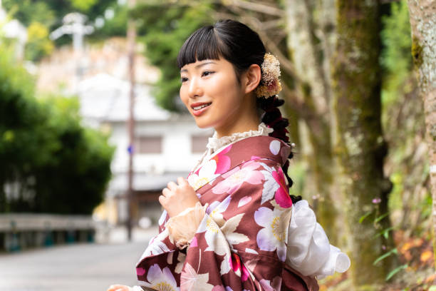 istock A woman in a kimono walking around town 2176661803
