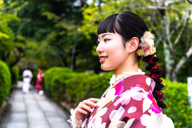 istock A woman in a kimono walking around town 2176661886